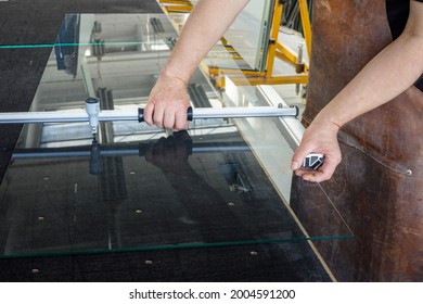 The Glazier Cuts A Large Sheet Of Glass. Glass Workshop, Specialist Work Tools 