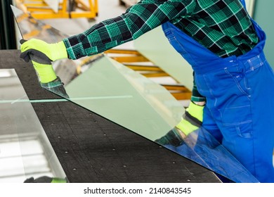 The Glazier Places A Pane Of Glass On A Specialized Table, Work In A Glass Factory 