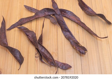 Gleditsia Triacanthos Tree Seed Pods On Wooden Background.