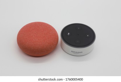 Glen Arm, MD / USA - June 20, 2020: New Google Nest Mini And First Generation Amazon Echo Dot Together In White Background. 