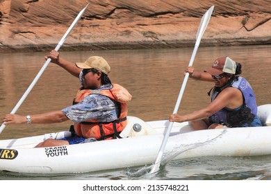 Glen Canyon National Recreation Area, Arizona, USA - circa  June 2015 - Group trip chaparones on Dine (Navajo) youth overnight river trip paddling inflatable on the Colorado River.