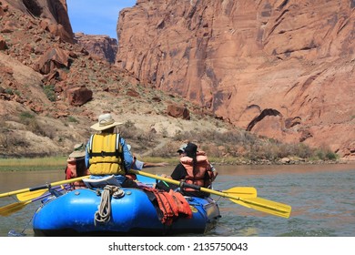 Glen Canyon National Recreation Area, Arizona, USA - circa  June 2015 - River guide on Dine (Navajo) youth overnight river trip paddling raft through canyon on the Colorado River.