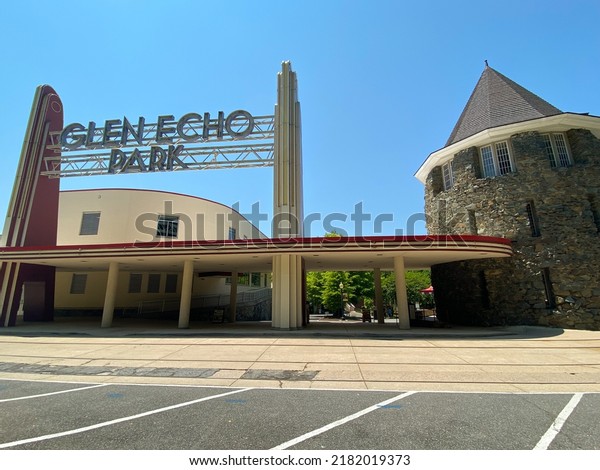 Glen Echo, Maryland - 2022: Glen Echo Park entrance with\
Chautauqua Tower. Renovated Streamline Moderne, Art Deco sign and\
circular stone tower from National Chautauqua Assembly. Trolley car\
rails. 