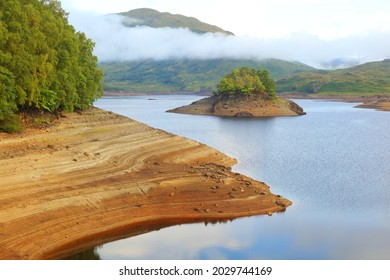 Glen Finglas reservoir showing soil Layers due to low water level. Trossachs, Scotland, UK.
