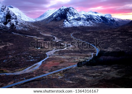Glencoe and Buchaille Etive Mor (L) and Buchaille Etive Beag (R) from halfway up Beinn A' Chrulaiste, showing the A82 road, at sunset. Stock photo © 