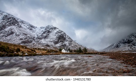 Glencoe, Scottish Highlands Winter Mountain Scene With Snow And A Fast Flowing River Coe. Scotland United Kingdom