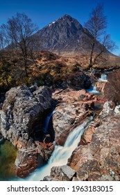 Glencoe Waterfall With Mountain Background And Blue Sky