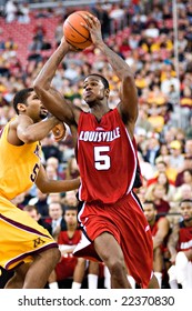 GLENDALE, AZ - DECEMBER 20: Earl Clark #5 Of Louisville Passes The Ball As Ralph Sampson #50 Of Minnesota Defends In The Basketball Game On December 20, 2008 In Glendale, Arizona.