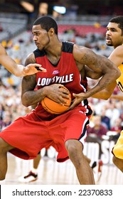 GLENDALE, AZ - DECEMBER 20: Earl Clark #5 Of Louisville Protects The Ball As Ralph Sampson #50 Of Minnesota Defends In The Basketball Game On December 20, 2008 In Glendale, Arizona.