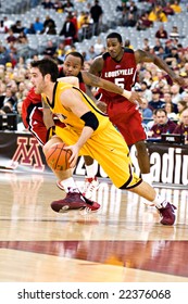 GLENDALE, AZ - DECEMBER 20: Minnesota's Travis Busch #4 Dribbles Past Louisville's Jerry Smith #34 And Earl Clark #5 On December 20, 2008 In Glendale, Arizona.