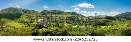 Glenfinnan Railway Viaduct panorama in Scotland with the steam train passing over