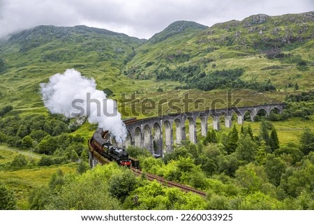 Glenfinnan railway viaduct in Scotland with the Jacobite steam train passing by, Scotland