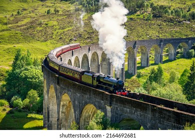 Glenfinnan Railway Viaduct In Scotland With The Steam Train Passing Over