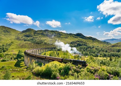Glenfinnan Railway Viaduct In Scotland With The Steam Train Passing Over