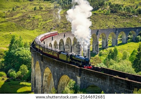 Glenfinnan Railway Viaduct in Scotland with the steam train passing over