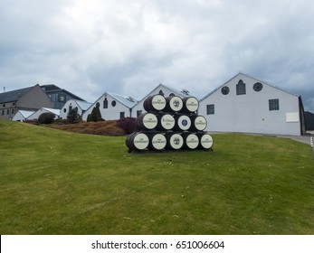GLENLIVET, SCOTLAND - 13 MAY 2017 - Whisky barrels used as signs outside the famous Glenlivet Distillery where traditional single malt whiskies are made.