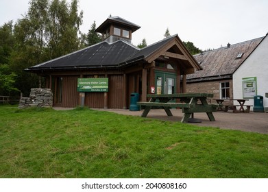 Glenmore, Scotland, UK, September 13 2021: Exterior Of Glenmore Visitor Centre In Cairngorms National Park. Wooden Bench In Front And Grassy Area. No People. Cloudy Day.