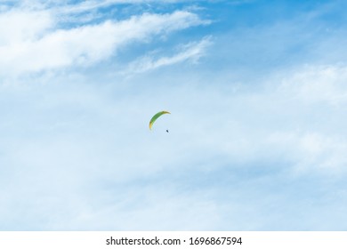 Glenwood Springs, USA Roaring Fork Valley In Colorado With Man Paragliding Isolated Parachute In Cloudy Blue Sky In Summer