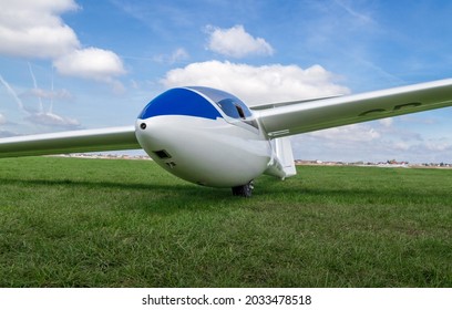 Glider Airplane On A Grass Runway.