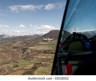 Glider being pulled up by a small airplane