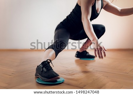 Gliding Disc Exercise. Woman Athlete