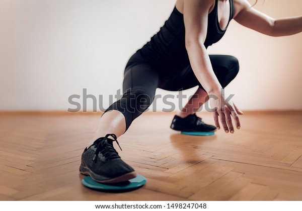 Gliding Disc Exercise. Woman\
Athlete