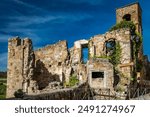 A glimpse of the ancient medieval village of Celleno, Viterbo, Italy. Ghost town, with houses in ruins, abandoned and uninhabited. The crumbling and collapsed walls of old ruined buildings.