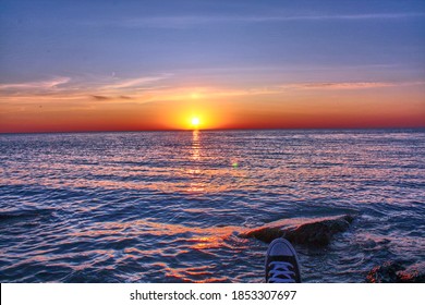 Glimpse of a Converse sneaker over looking Lake Michigan, Chicago Il. During a beautiful sunrise.