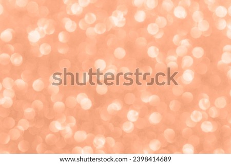 Glitter abstract bokeh background, texture. Lights festive background concept. Color of the year 2024 Peach Fuzz.