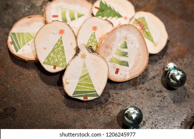 glitter balls and selfmade christmas decoration: napking technique on birch wood - iron background
