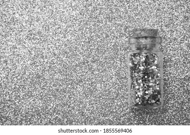 Glitter in bottle isolated on gray, silver background - Powered by Shutterstock