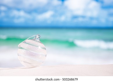 Glitter Christmas Glass Ball On  Beach With Seascape Background