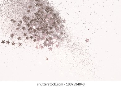 Glitter and glittering stars on light gray background in vintage colors