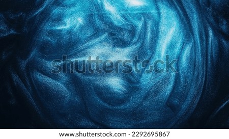 Glitter liquid. Paint water. Shiny swirl. Oracle sphere. Blue color glowing shimmering grain texture smoke cloud on dark black abstract art background.