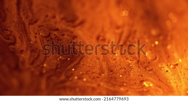 Glitter paint flow. Molten gold texture.\
Floating ink. Defocused yellow orange sparkling fluid motion.\
Abstract art background shot on RED Cinema\
camera.