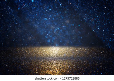 Glitter Vintage Lights Background. Black, Blue And Gold. De-focused