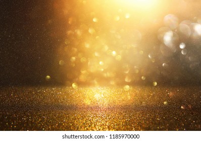 Glitter Vintage Lights Background. Black And Gold. De-focused