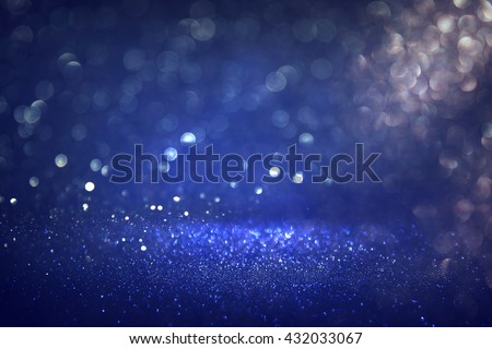 glitter vintage lights background. black, silver and blue. defocused
