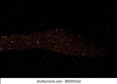 glitter vintage lights background. dark gold and black. defocused
