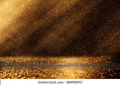 glitter vintage lights background. dark gold and black. de focused