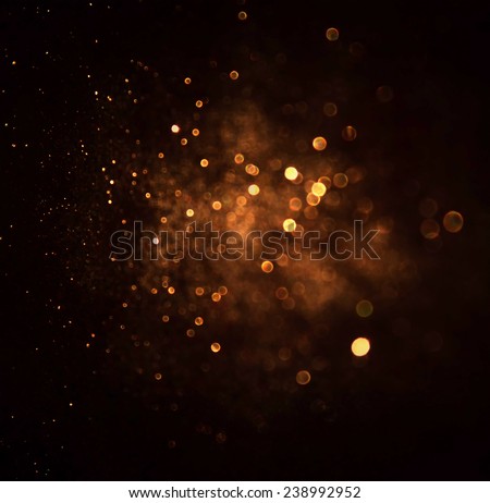 glitter vintage lights background. dark gold and black. defocused 