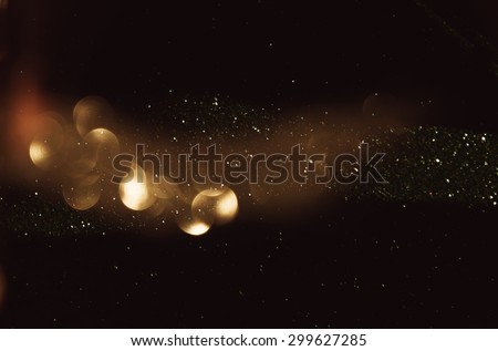 glitter vintage lights background. dark gold and black. defocused
