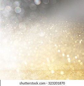 Glitter Vintage Lights Background. Gold, Silver, And Black. De-focused. 