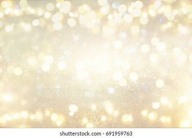 glitter vintage lights background. silver and light gold. de-focused.