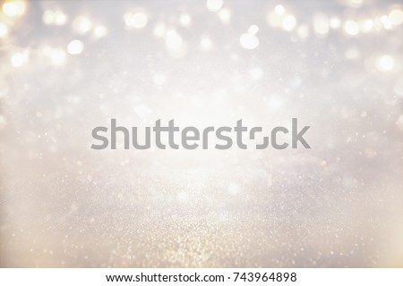 glitter vintage lights background. silver and light gold. de-focused.