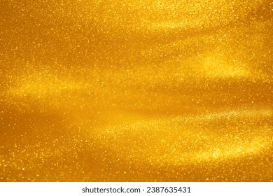 Glittering flows of gold particles in fluid. Various stains and overflows of gold particles in liquid with yellow tints. Abstract shimmering background.