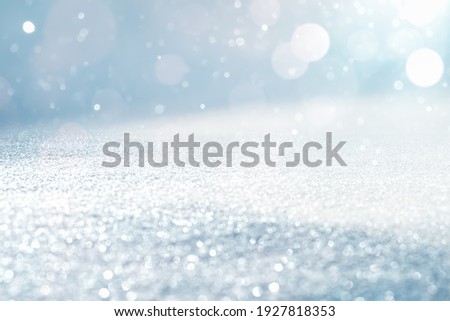 GLITTERING ICE WITH BOKEH LIGHTS, CHRISTMAS BACKDROP WITH BLANK SPACE FOR DISPLAY CHRISTMAS PRESENTS OR WINTER FRESH PRODUCTS