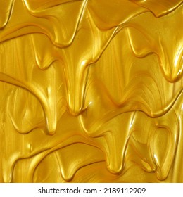 Glittering shiny metallic gold paint flowing and dripping downward making a golden background. - Shutterstock ID 2189112909