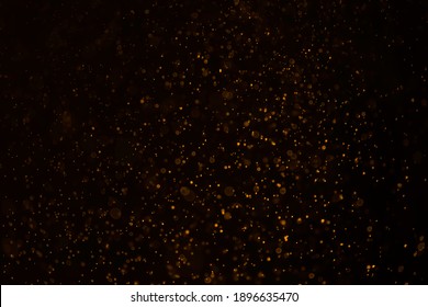 Glittering stars of bokeh use for celebrate background. Luxury gold bokeh on black background for decoration