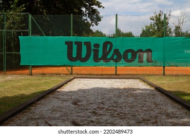 GLIWICE, POLAND - AUGUST 2, 2022: Wilson Sporting Goods Company Logo Sign On Outdoor Tennis Court Fencing. American Sports Equipment Manufacturer Brand Logotype Banner.